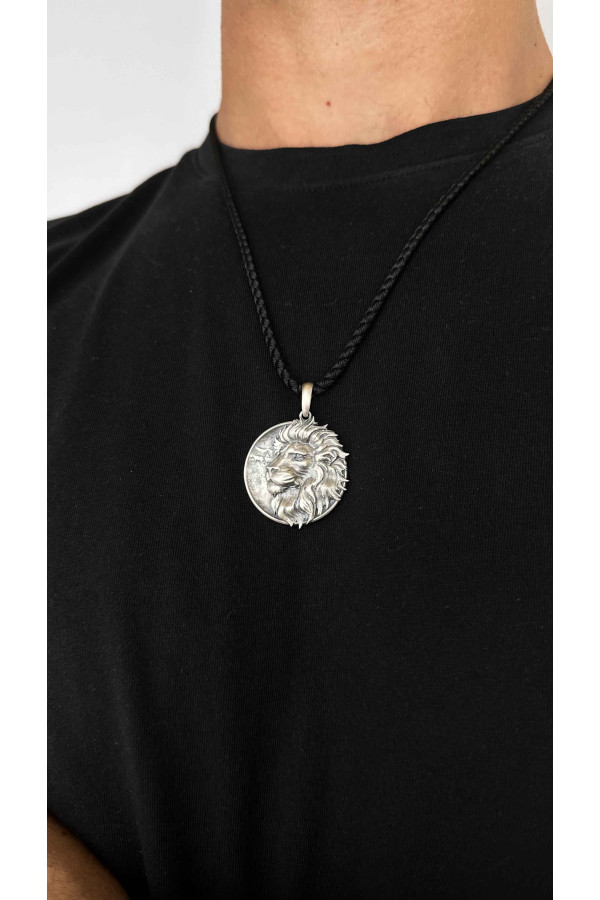 Silver amulet pendant with the image of a lion