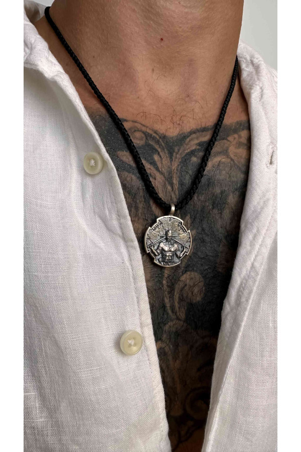 Silver amulet pendant with the image of a Cossack