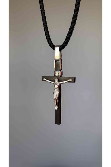 Minimalistic cross made of silver on Ebony